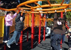 Child on play equipment in West Street Playground