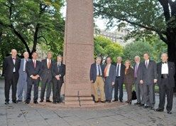 The 2009 American Nobel Laureates stand at the monument in Theodore Roosevelt Park. 