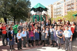 Cutting the ribbon with students from St. Athanasius School at Fox Playground.