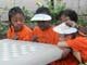 Kids sitting at a chess table in Brownsville Playground
