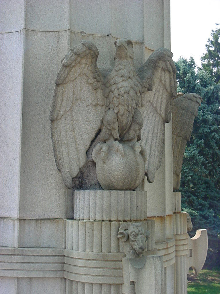 Four columns, each with four small eagles surmounting globes at middle sections and one large eagle surmounting globe at top