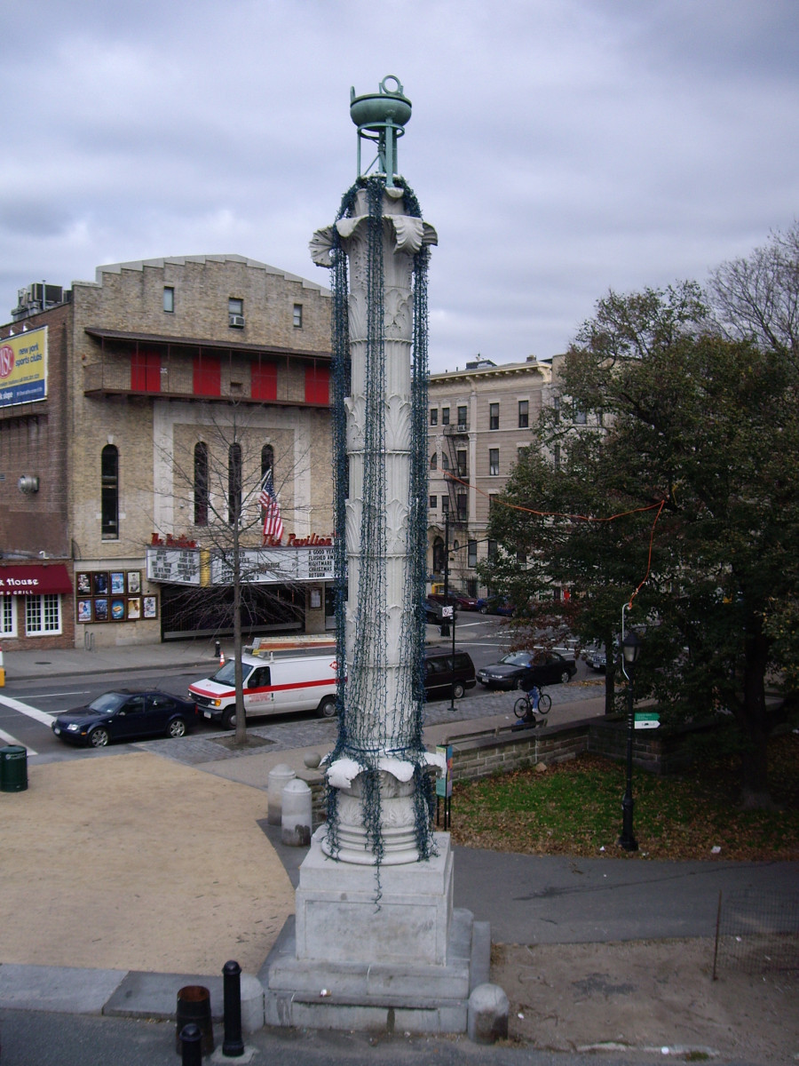 Two columns on high square plinths, each topped by a tripod and bowl