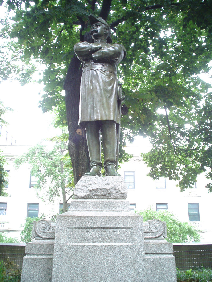 Standing figure (over life size) on rock on pedestal