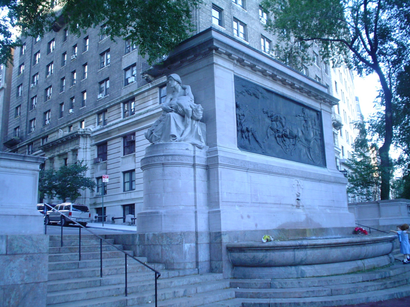 Monumental sarcophagus-like structure with a bas-relief, groups of figures (over life size) at either end, on terrace with fountain, and balustrades approached by a flight of steps