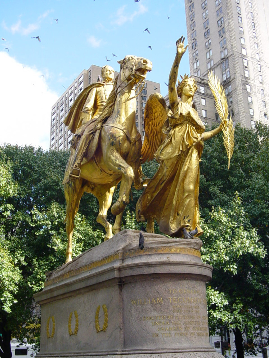 Group (heroic scale) consisting of equestrian figure and female figure on pedestal decorated with six applied wreaths (three on each side), plaque set in pavement