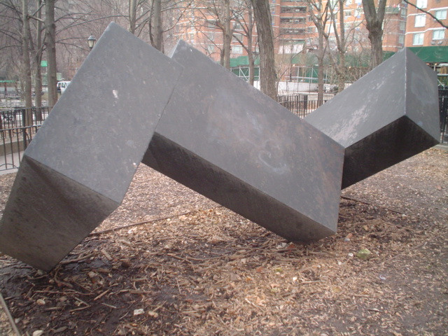 Three solid rectangular forms, joined at different angles in a line, and balanced on three points