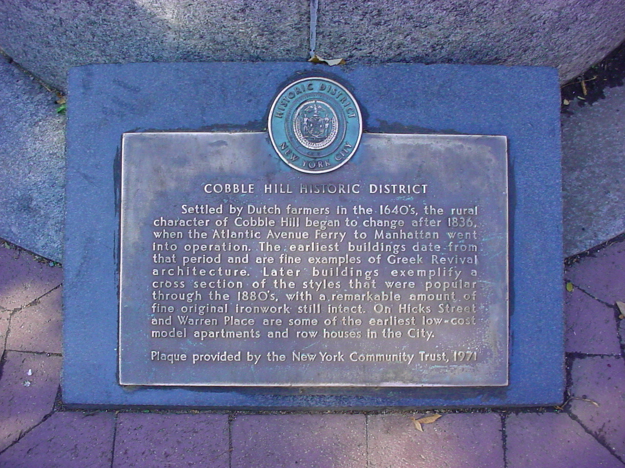 Plaque with medallion at top, on plinth