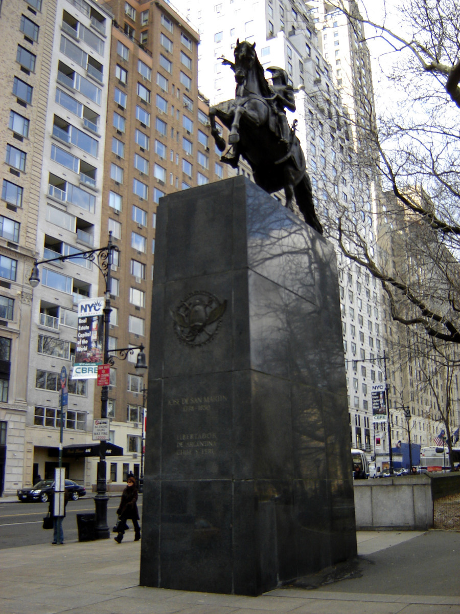 Equestrian figure (over life-size)on integral plinth, on pedestal with escutcheon