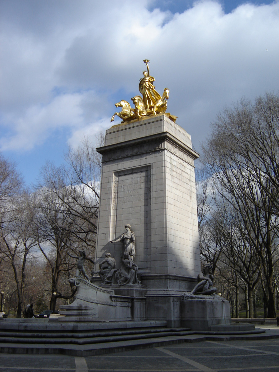 Pylon fountain embellished with colossal group, nine figures (heroic scale), and frieze; three plaques (two large, one small); four gate houses, each with a door and three low reliefs