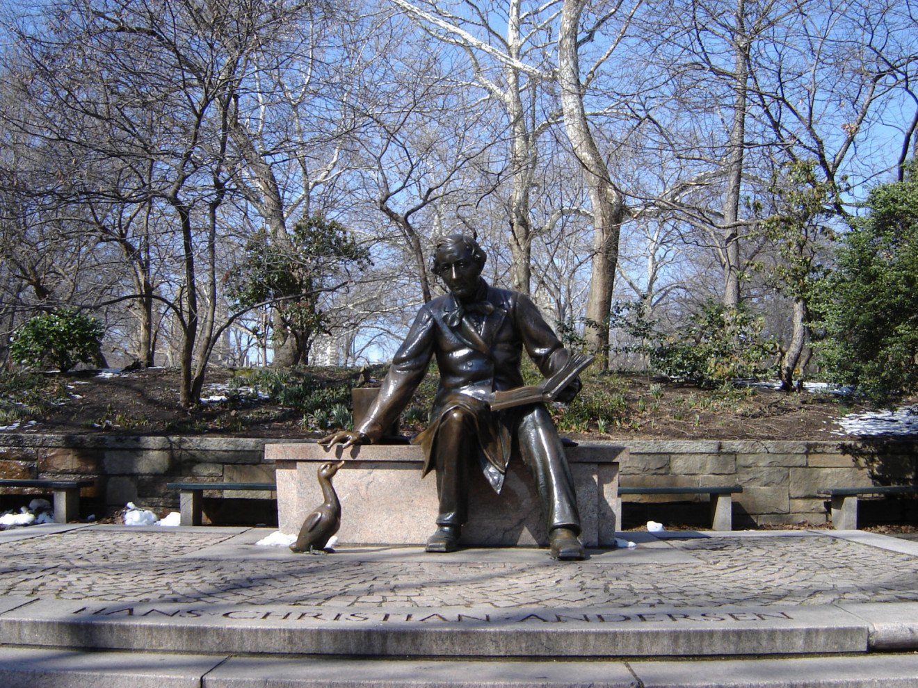 Seated figure (heroic scale) on bench, cygnet figure