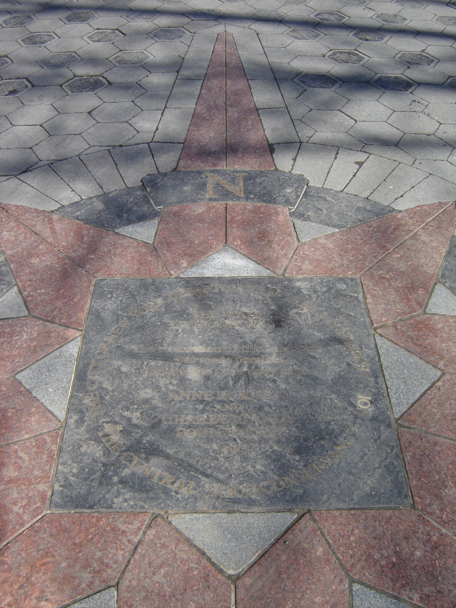 Sidewalk intaglio with inset lettering and compass motif