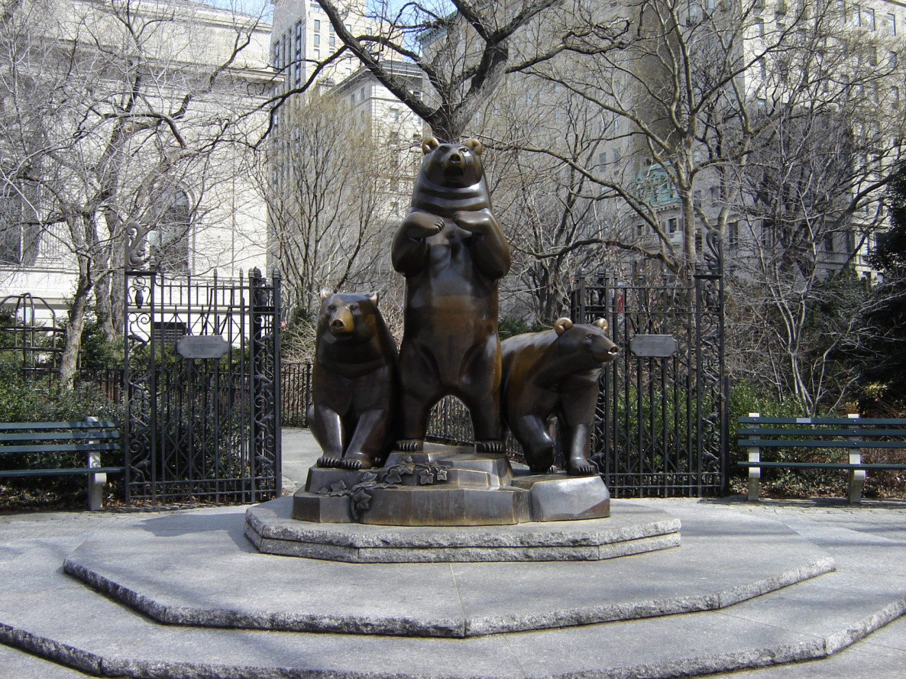 Group of three on integral, graduated plinth on circular pedestal with five steps; plaque