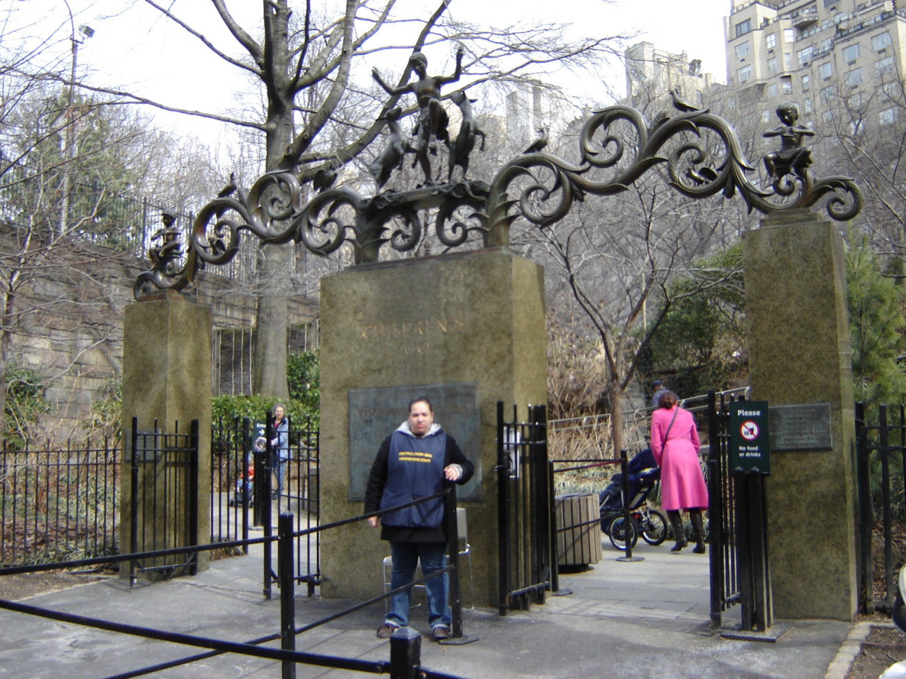 Three pylons surmounted by ornamental crest with children, animal, and bird figures; three plaques