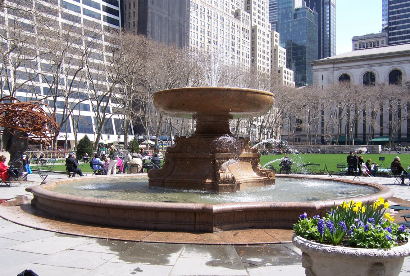 Ornamental fountain with tablet set into ground