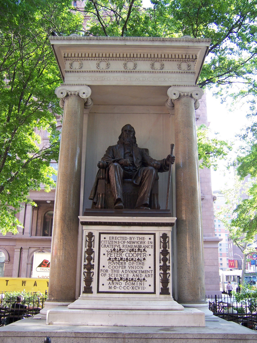 Seated figure (over life-size), on pedestal, under a canopy