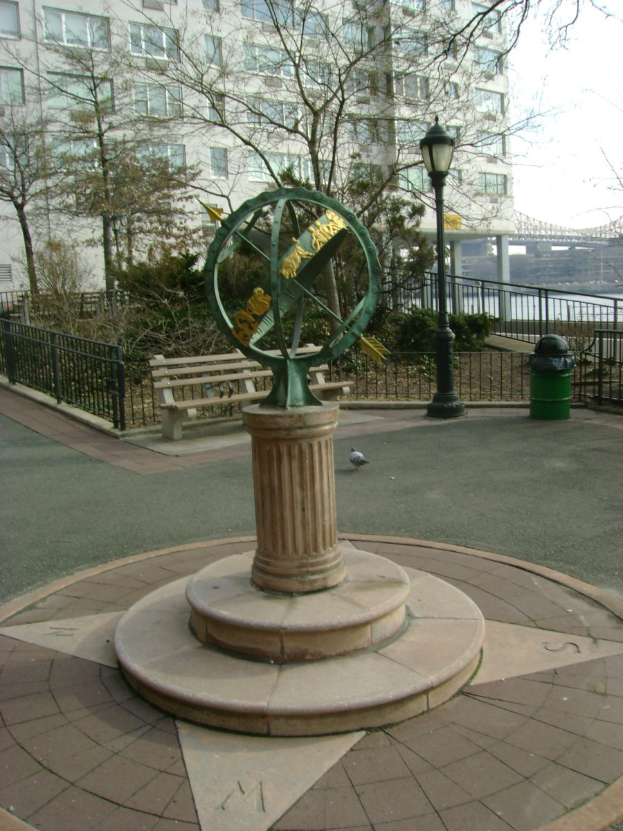 Armillary sphere and sundial on circular pedestal