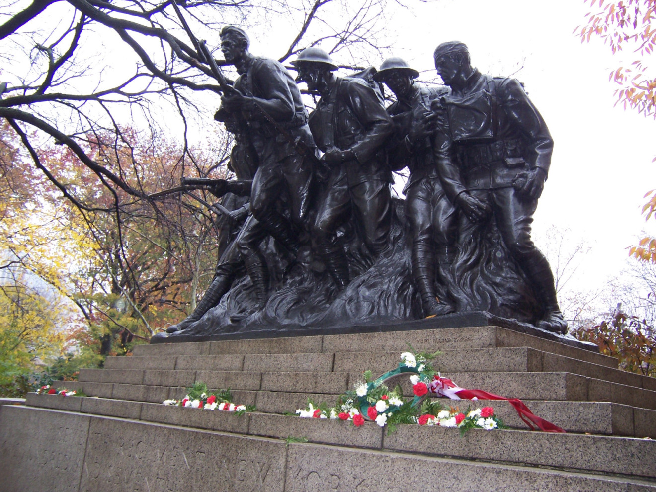 Group of seven figures (over life-size) with integral plinth, on a pedestal