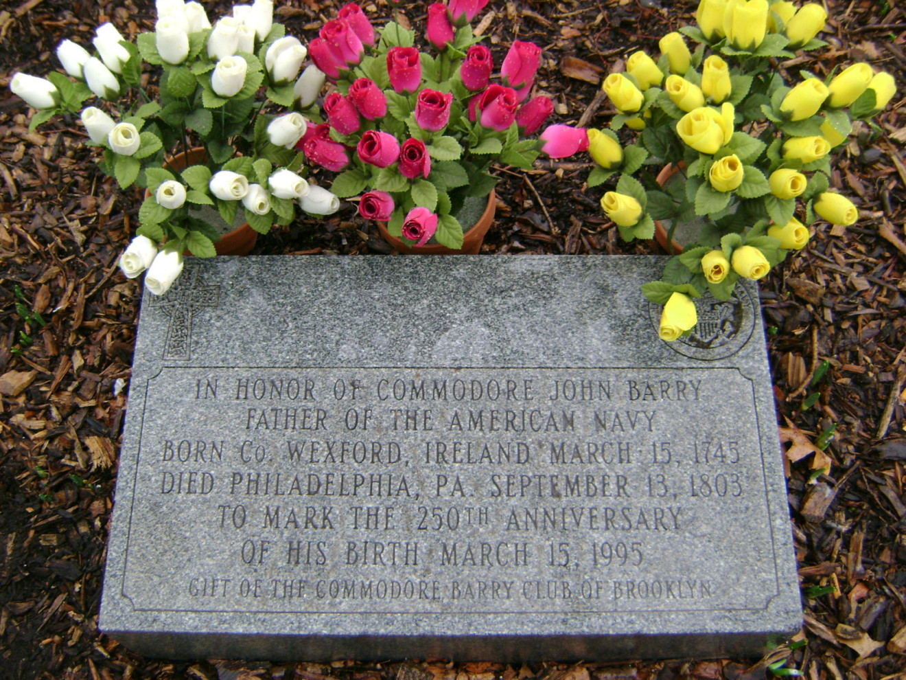 Inscribed stele with Celtic cross and US Navy seal at top and text below