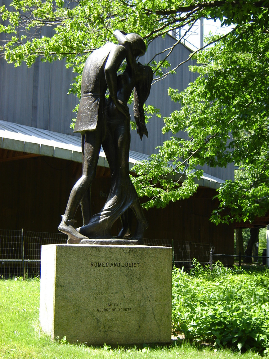 Over life-size group of two figures on pedestal