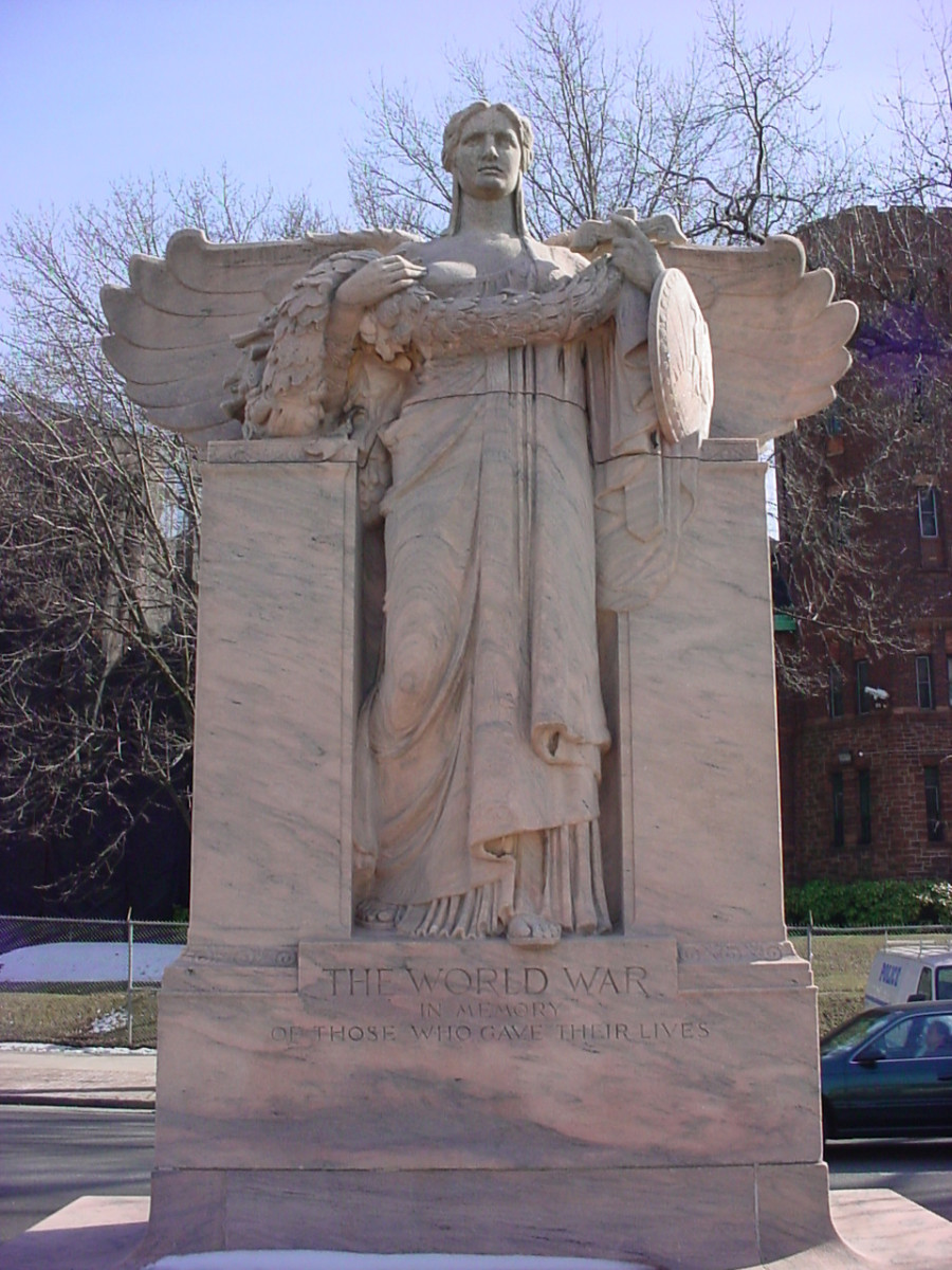 Standing, winged female figure (heroic scale) on pedestal, in front of stele, benches at sides