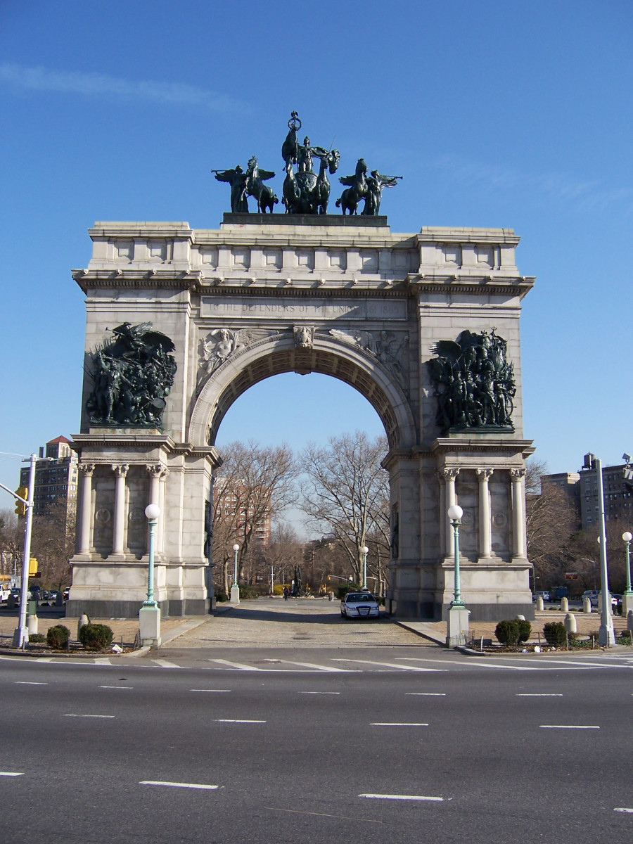 Triumphal arch; bas-relief figures in spandrels on south face; seal of city of Brooklyn and seal of New York state in spanrels on north face; sixteen medallions, four on each of the pier stages at south and north faces