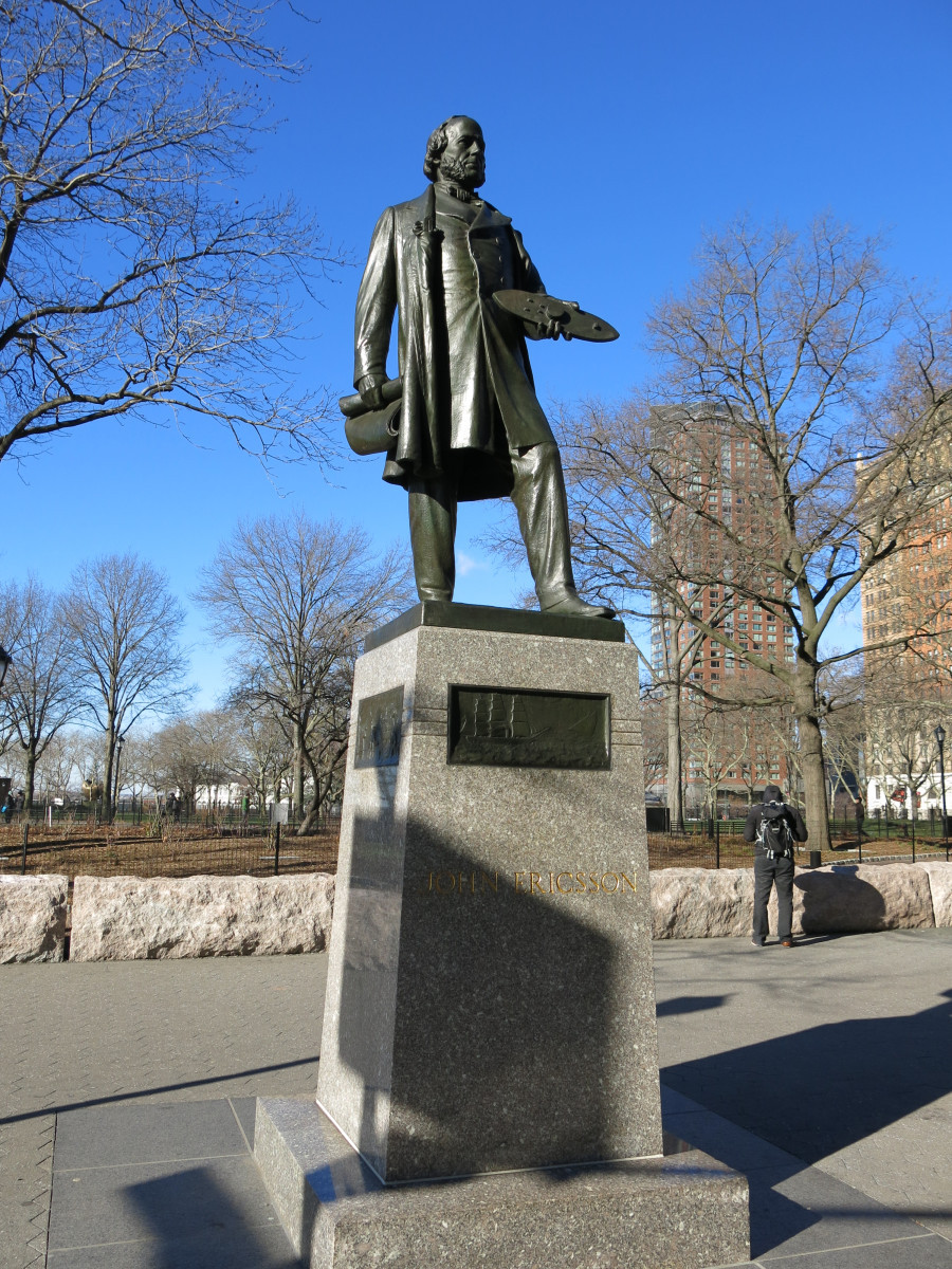 Figure (heroic scale) on integral plinth, pedestal with four recessed relief plaques