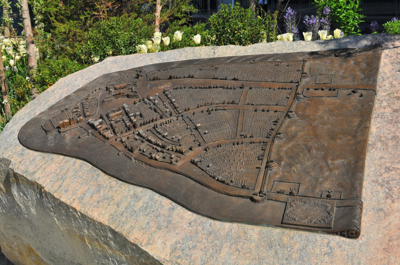 Three-dimensional plaque on natural boulder; nine narrative stones in pavement