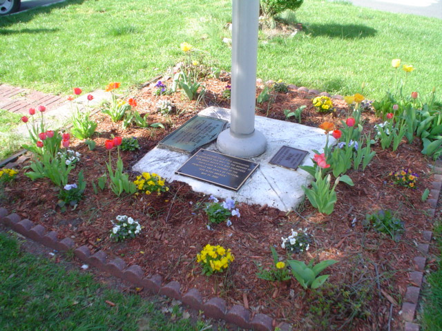 3 plaques on concrete flagstaff