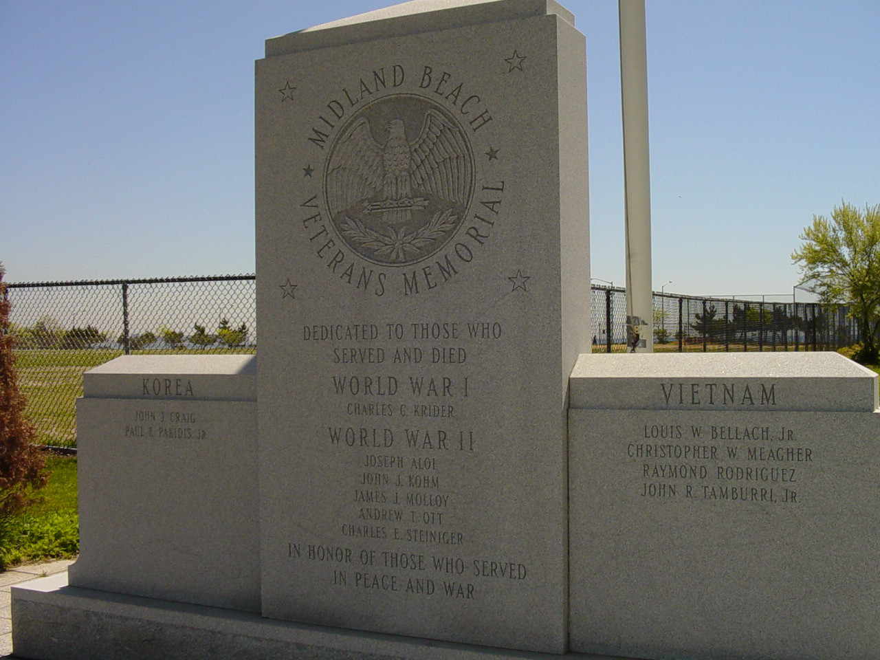 Tripartite upright slab with incribed eagle atop pedestal