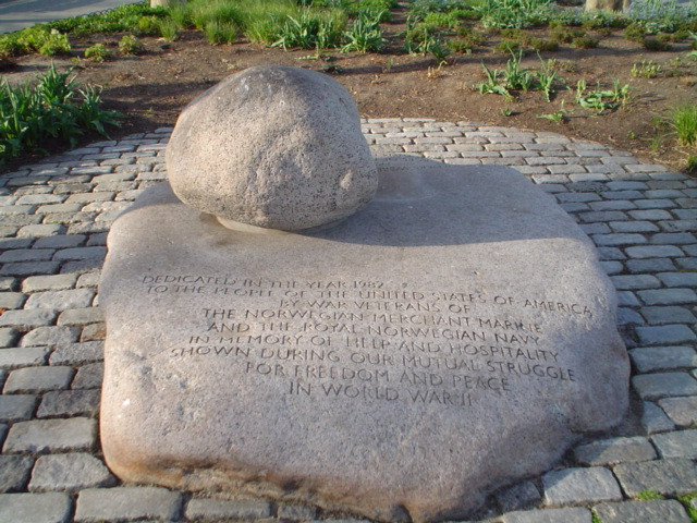 Small boulder with incised anchor motif, atop large inscribed boulder, inscribed marker