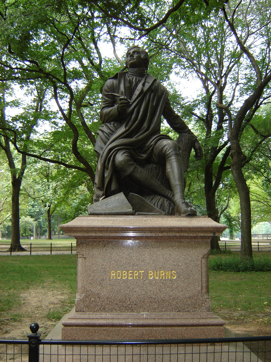 Seated figure (over life-size) with scroll and plough at feet, on pedestal