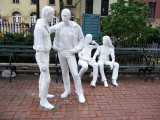 Group of four figures (two seated, two standing), two World's Fair-style benches, plaque