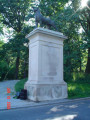 Two striding panthers on integral plinths, each on its own pedestal, framing the pedestrian entranceway