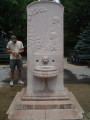 Stele with curved top; on front a bas relief over a shell basin with lion-head spouting fountain