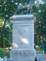 Two striding panthers on integral plinths, each on its own pedestal, framing the pedestrian entranceway