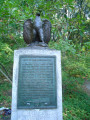 Eagle on integral plinth on stele on base, two plaques (one mounted on stele, one in ground before stele)