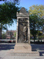 Stele on plinth on step; stele with bas-reliefs on north and south sides, and plaques on east and west sides