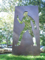 Sculpture; rectangular bronze structure with cut-out male figure; four engraved stone markers