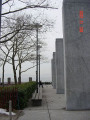 Eagle on pedestal between two ranks of four inscribed pylons (eight pylons in all; axis aligned with Statue of Liberty)