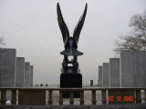 Eagle on pedestal between two ranks of four inscribed pylons (eight pylons in all; axis aligned with Statue of Liberty)