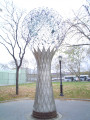 Tree trunk figure, globe constructed of a transparent matrix of coated rods with fittings at connecting points