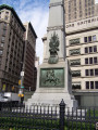 Obelisk decorated with applied trophy, die decorated with high relief panel, graduated base; tomb, two plaques, ornamented fence (three sides only), four gas lamp posts