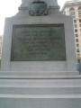 Obelisk decorated with applied trophy, die decorated with high relief panel, graduated base; tomb, two plaques, ornamented fence (three sides only), four gas lamp posts