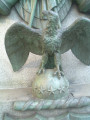 Obelisk decorated with applied trophy, die decorated with high relief panel, graduated base; tomb, two plaques, ornamented fence (three sides only), four gas lamp posts