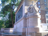 Monumental sarcophagus-like structure with a bas-relief, groups of figures (over life size) at either end, on terrace with fountain, and balustrades approached by a flight of steps