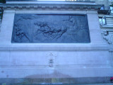 Monumental sarcophagus-like structure with a bas-relief, groups of figures (over life size) at either end, on terrace with fountain, and balustrades approached by a flight of steps