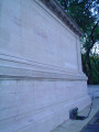 Monumental sarcophagus-like structure with a bas-relief, groups of figures (over life size) at either end, on terrace with fountain, and balustrades approached by a flight of steps