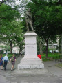 Standing figure (over life-size) on integral plinth on pedestal