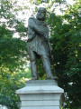 Standing figure (over life-size) on integral plinth on pedestal