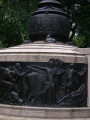 Flagstaff on drum pedestal with two bas-reliefs and two plaques